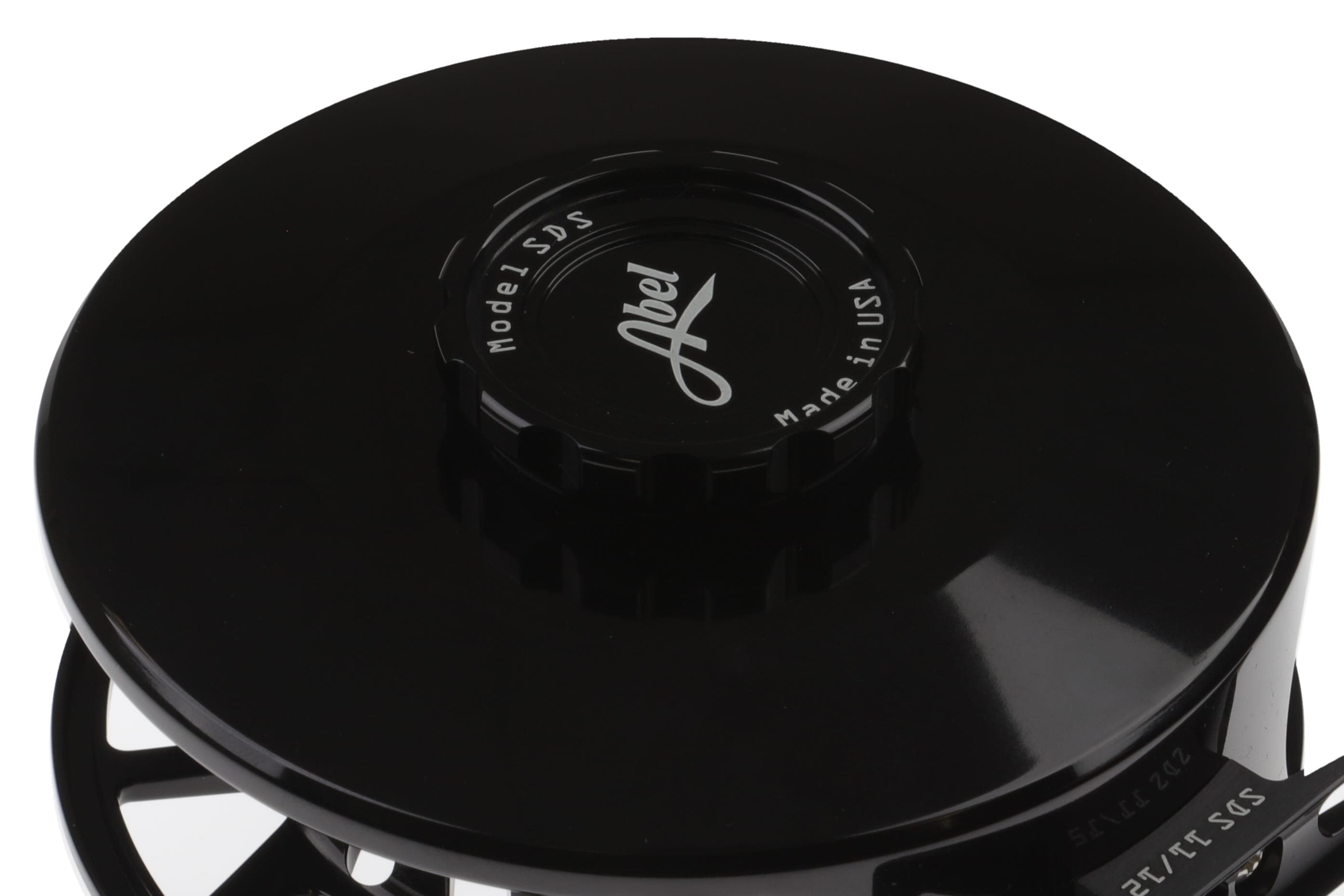 Black glossy anodized aluminum Abel SDS fly reel spool with engraved Abel logo and ridged drag cap
