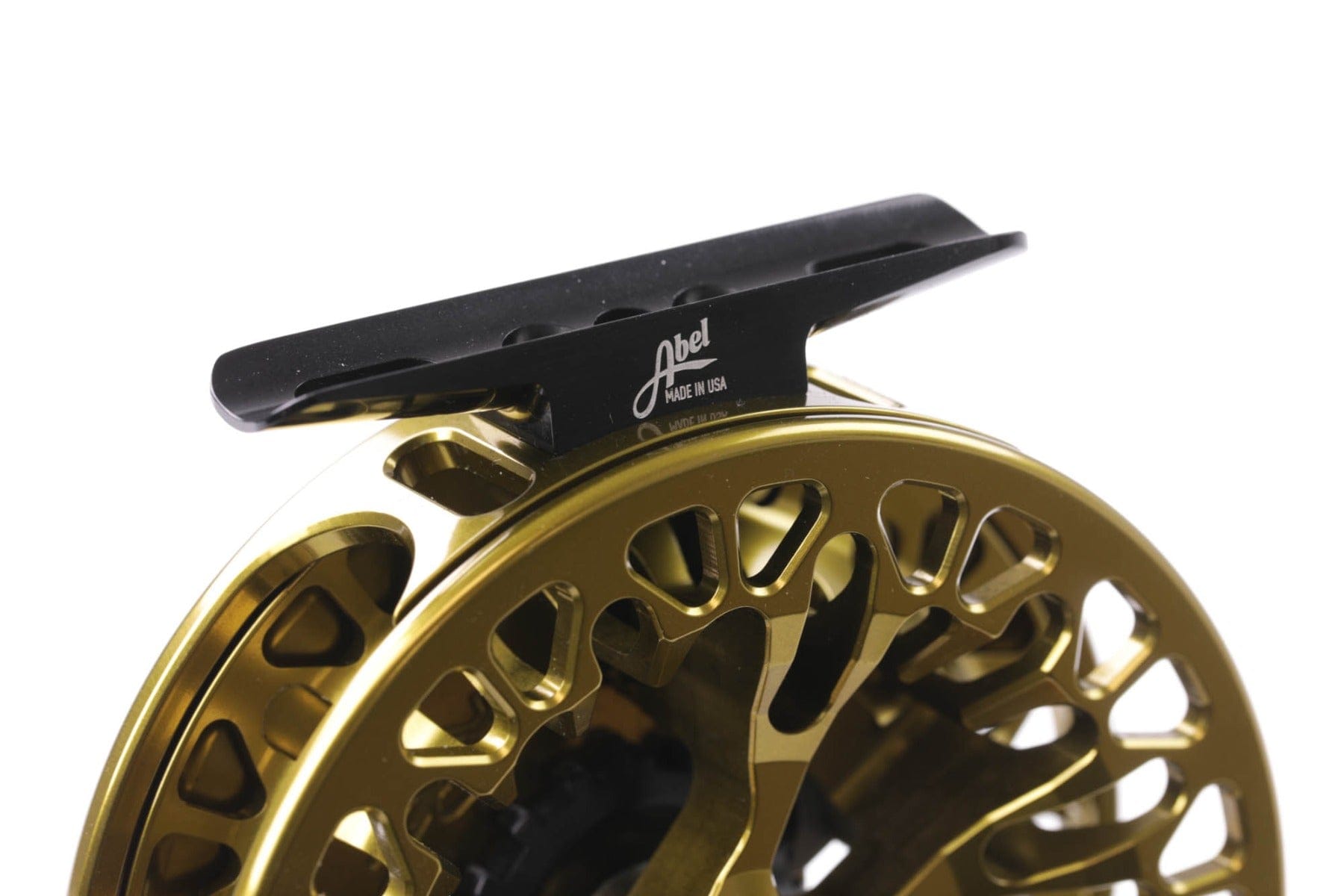 Abel VAYA gold anodized machined aluminum fly reel with skeletonized large-arbor spool and black mounting foot with Abel logo
