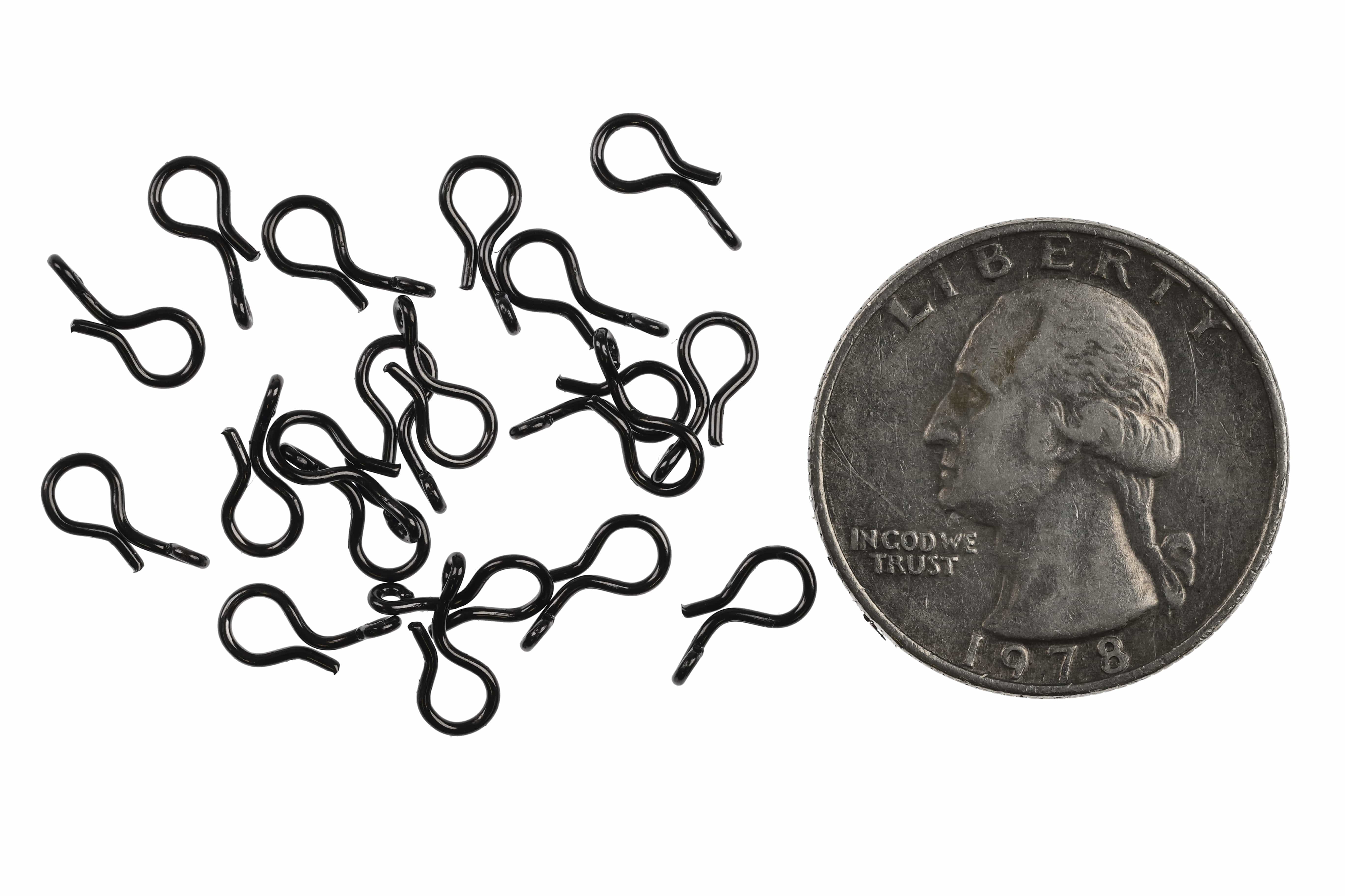 Ahrex quick-change black coated steel snaps scattered beside US quarter for scale