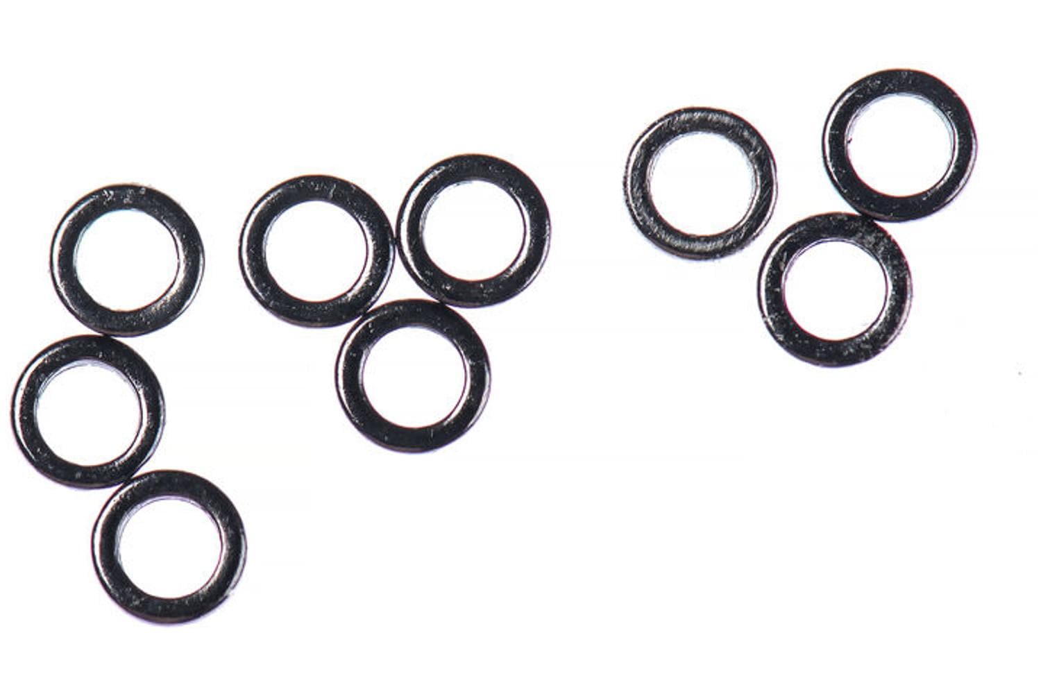 Ahrex tippet rings - small black glossy metal fly fishing accessory rings scattered on white background