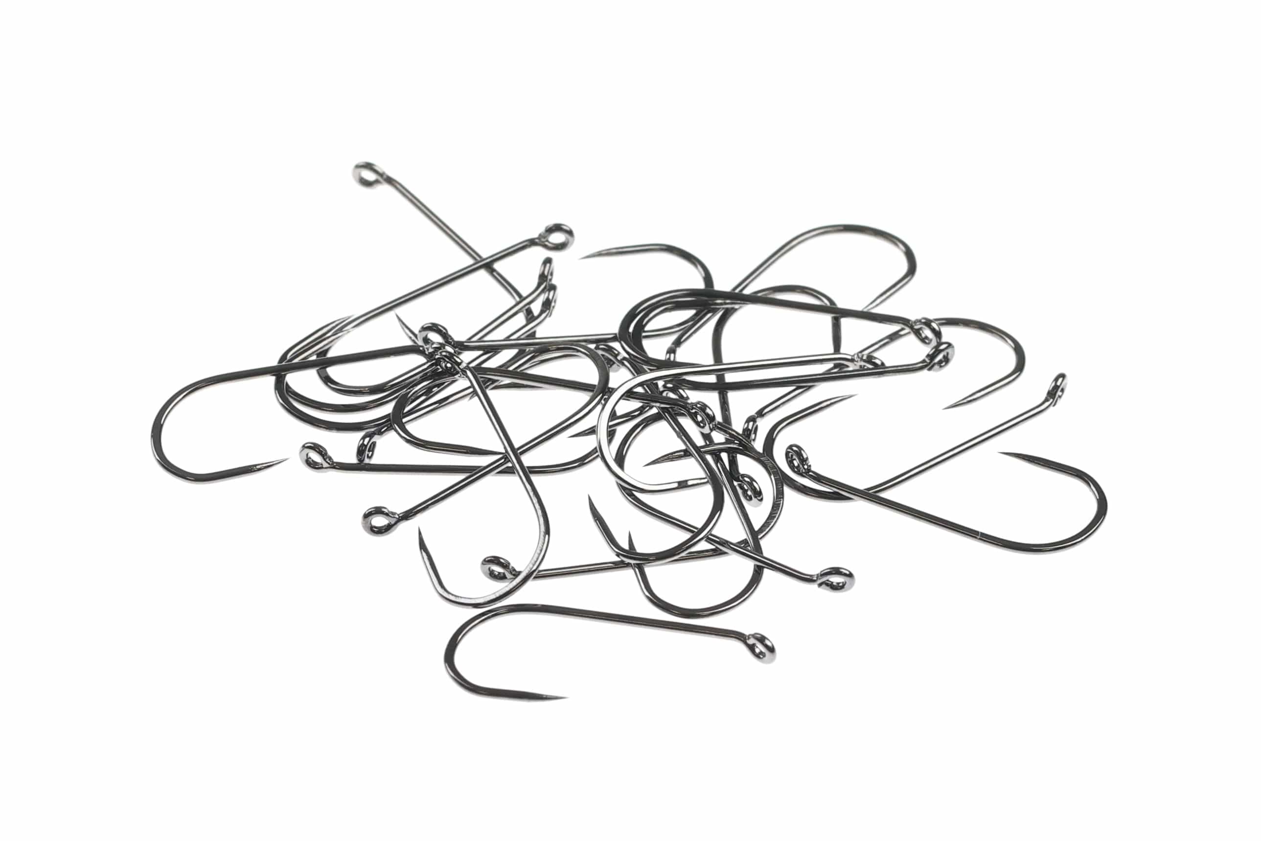 Pile of shiny nickel barbless dry fly hooks with straight eyes and thin curved shanks for fly tying
