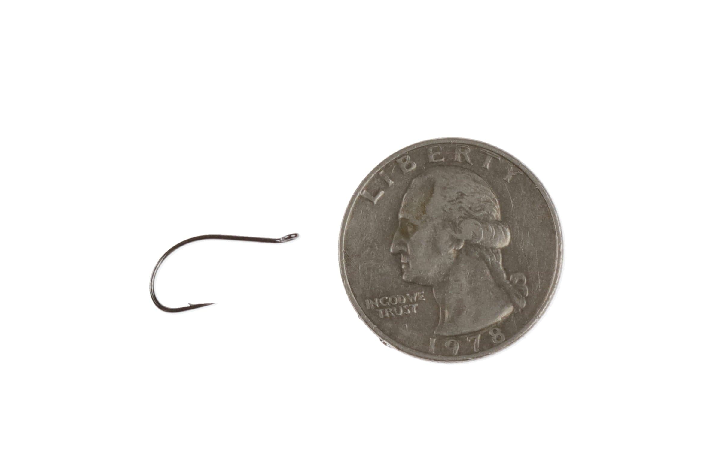 Ahrex FW520 emerger hook, small bronze curved fine-wire hook with upturned eye next to US quarter for scale, fly tying