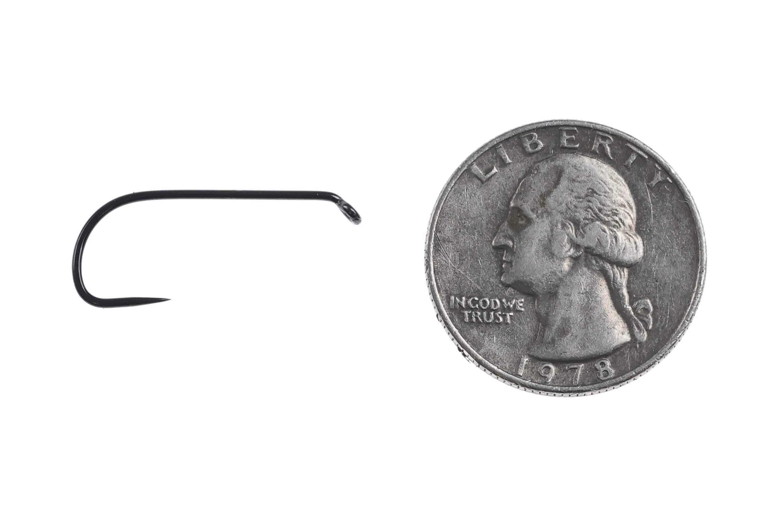 Ahrex long barbless dry fly hook black matte long-shank with turned-down eye beside US quarter for scale