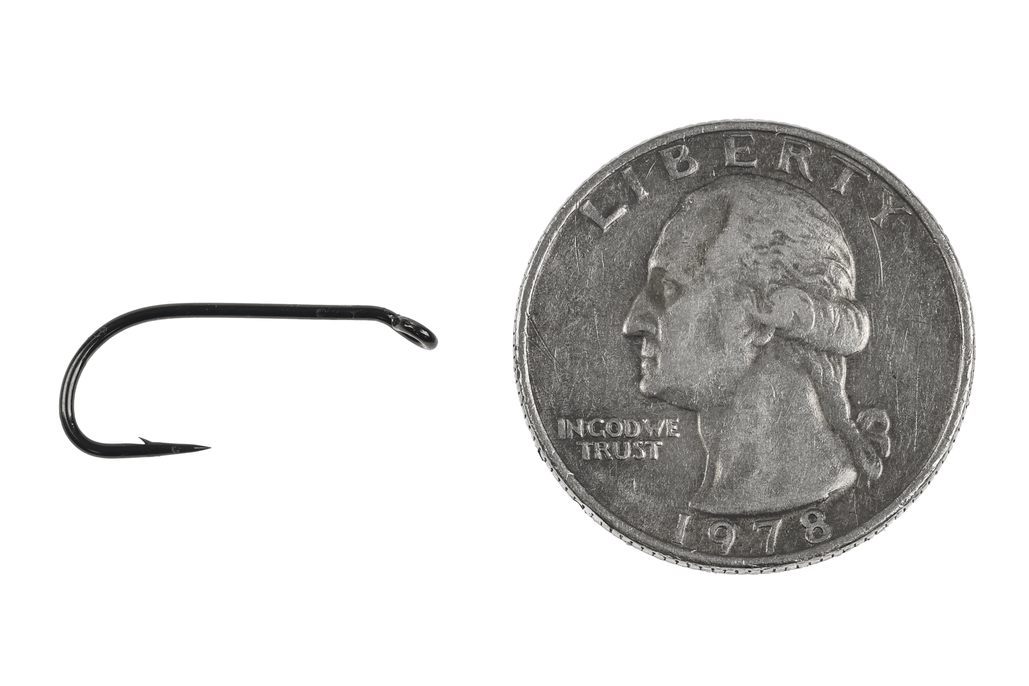 Black Ahrex FW580 wet fly hook with curved shank and small barb shown next to US quarter for scale