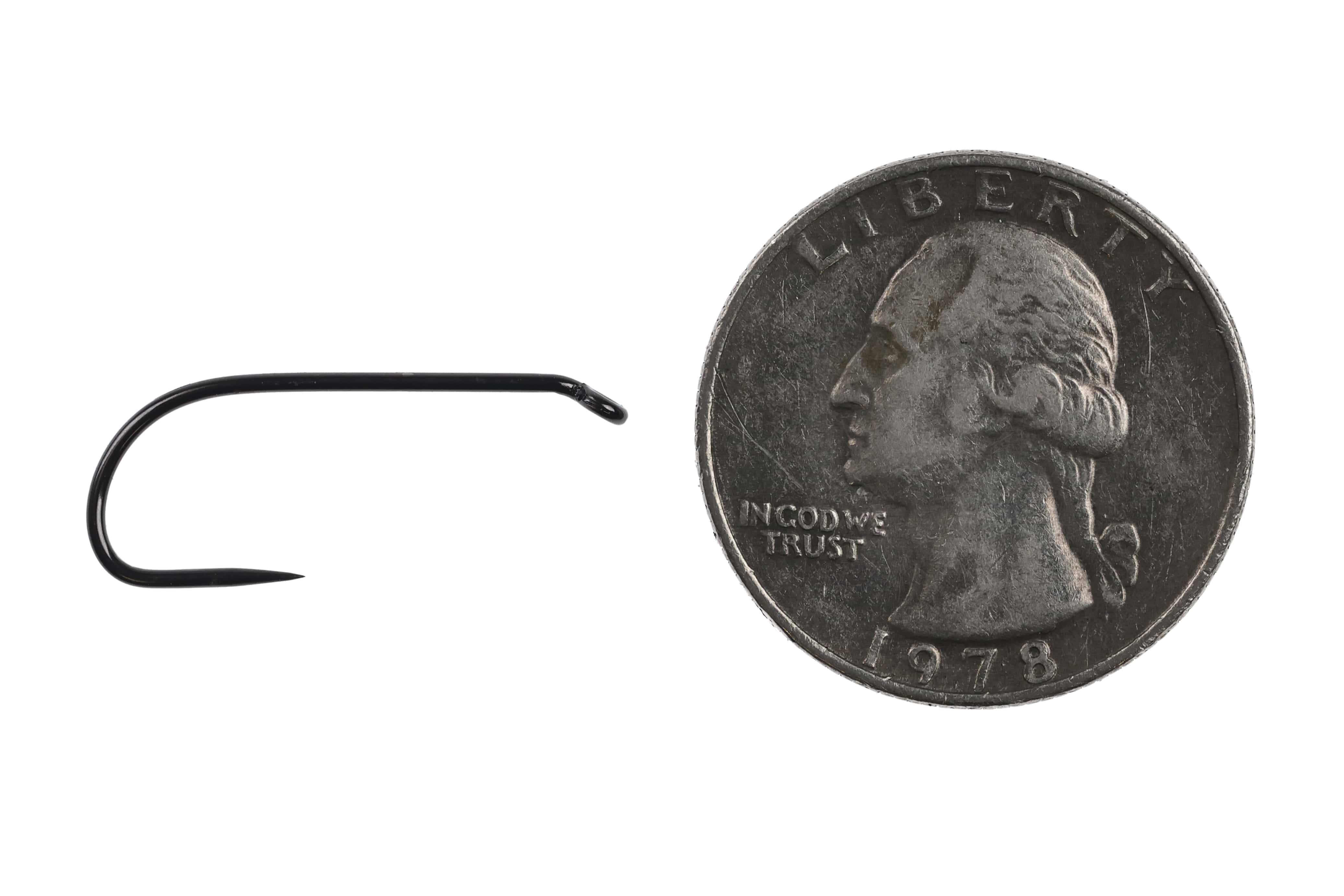 Black Ahrex FW581 barbless wet fly hook with glossy curved shank and fine point beside a US quarter for scale