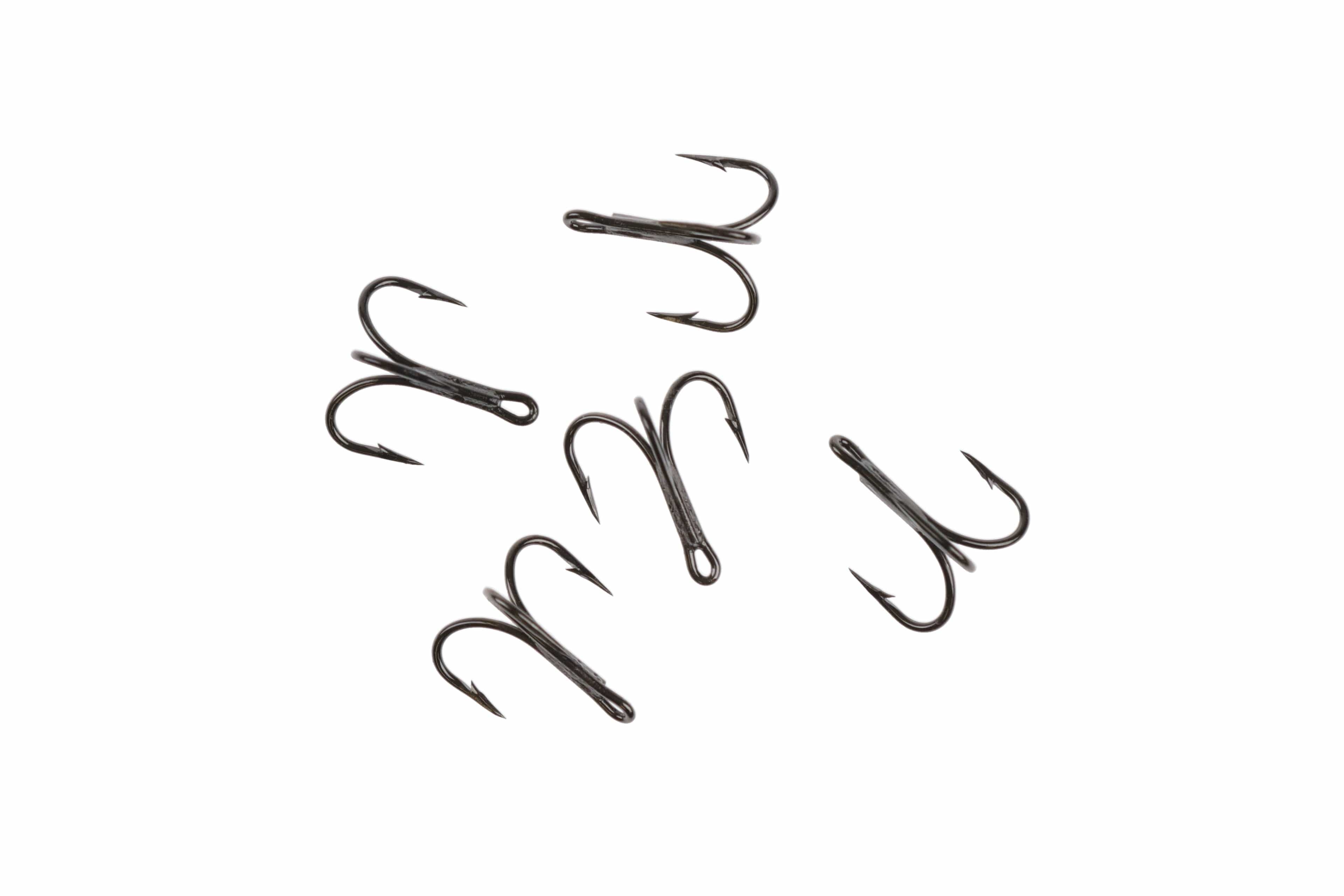 Black nickel Ahrex HR450 tube treble hooks with three barbed points and hollow tube shank for fly tying, scattered on white.