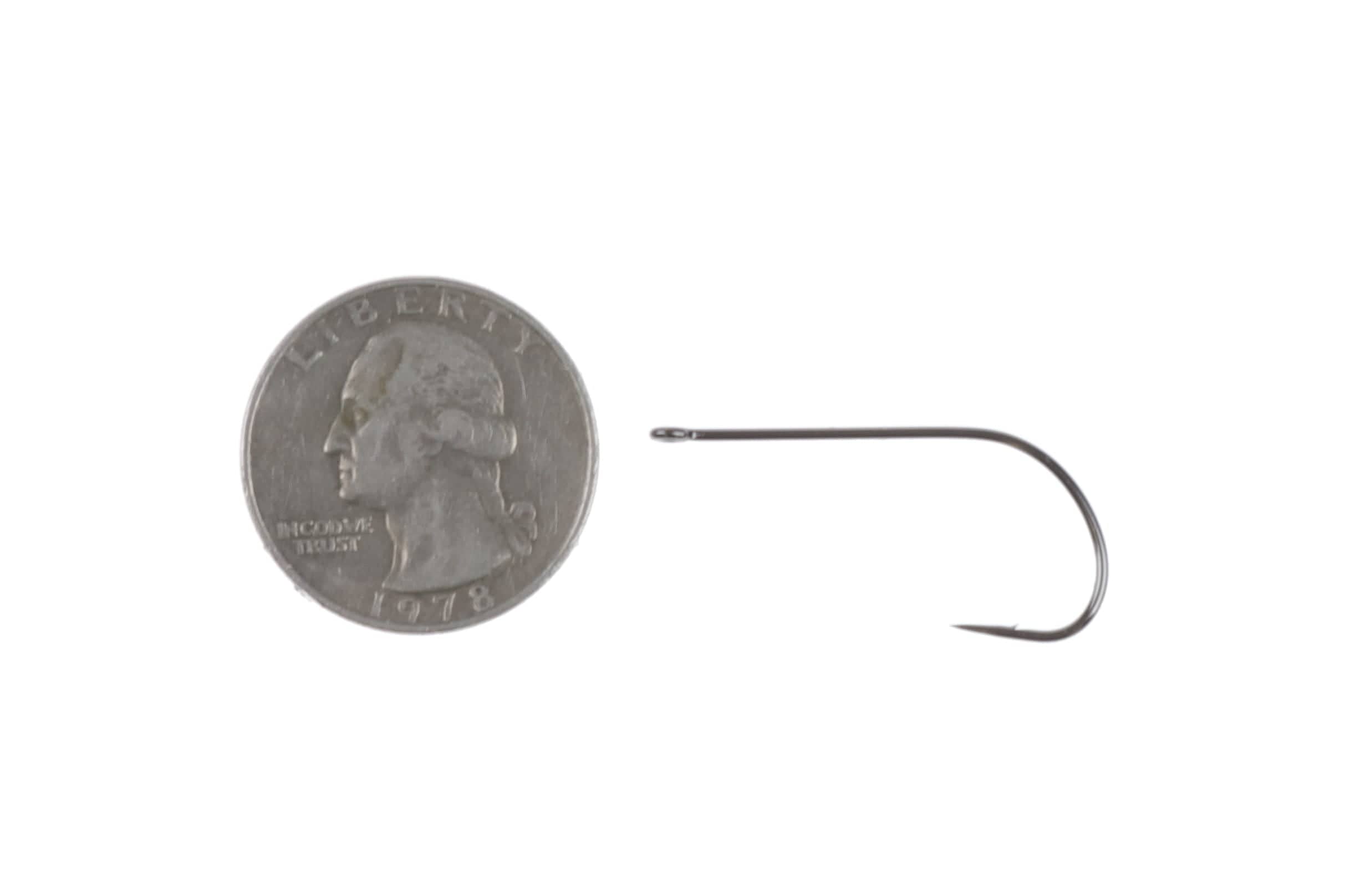 Ahrex NS122 stinger fly tying hook, gunmetal steel curved shank with straight eye beside US quarter for scale