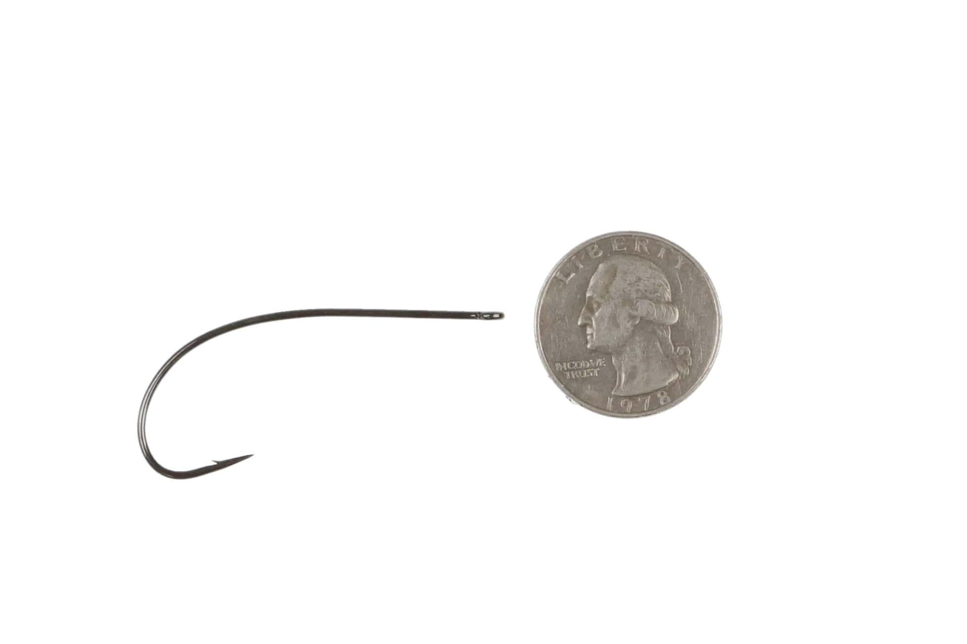 Ahrex PR350 light predator fly-tying hook, dark gunmetal thin wire curved shank with needle eye beside US quarter for scale