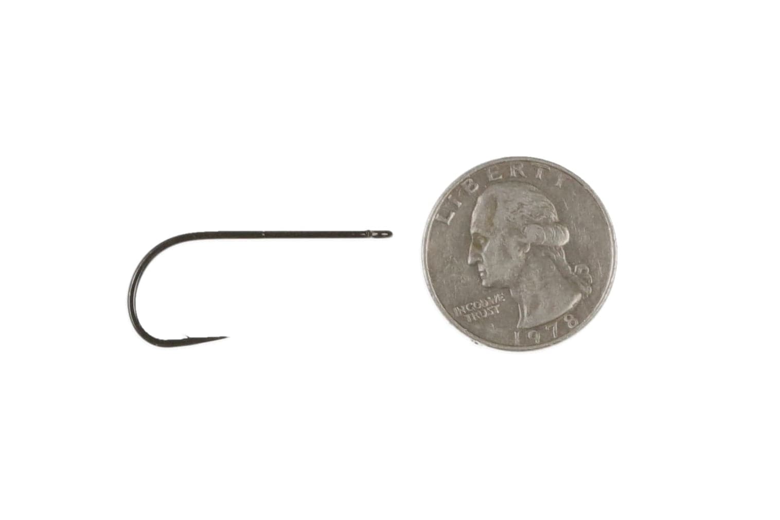 Ahrex TP610 long-shank black-nickel streamer hook for fly tying, curved bend and needle eye beside US quarter for scale