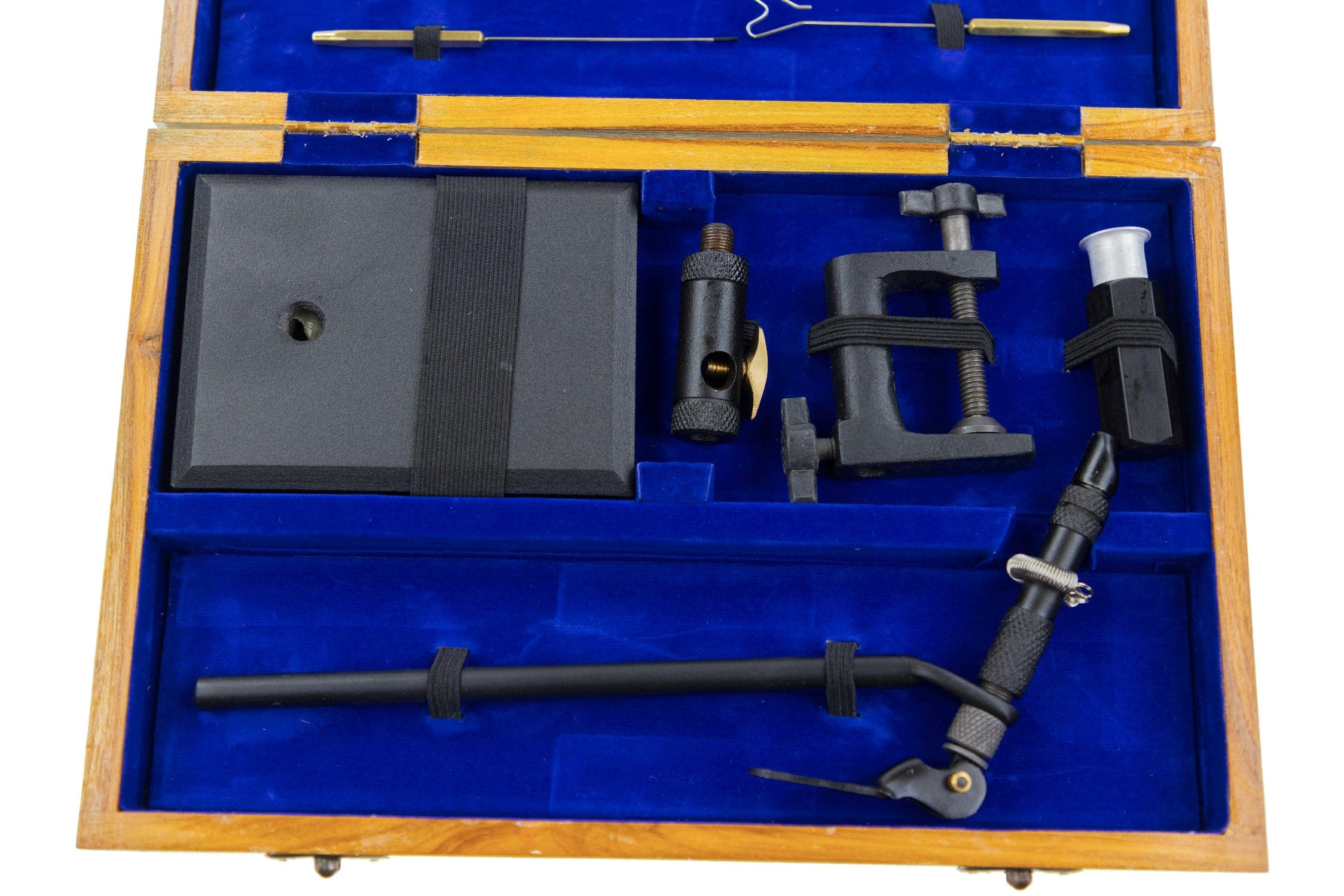 Wooden fly tying kit in a honey wood box with royal blue velvet interior, black metal vise, tools and foam block