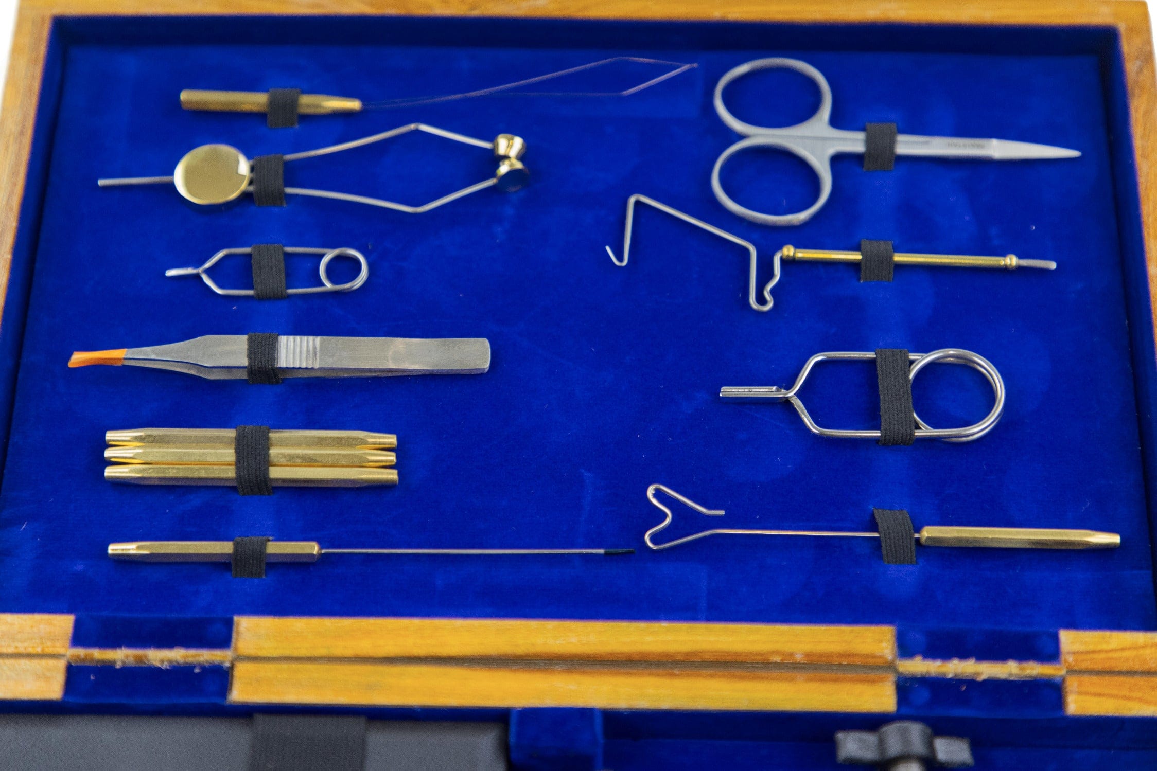 Angler Haus fly tying kit in wooden case with blue velvet lining and brass and steel tools like scissors and tweezers