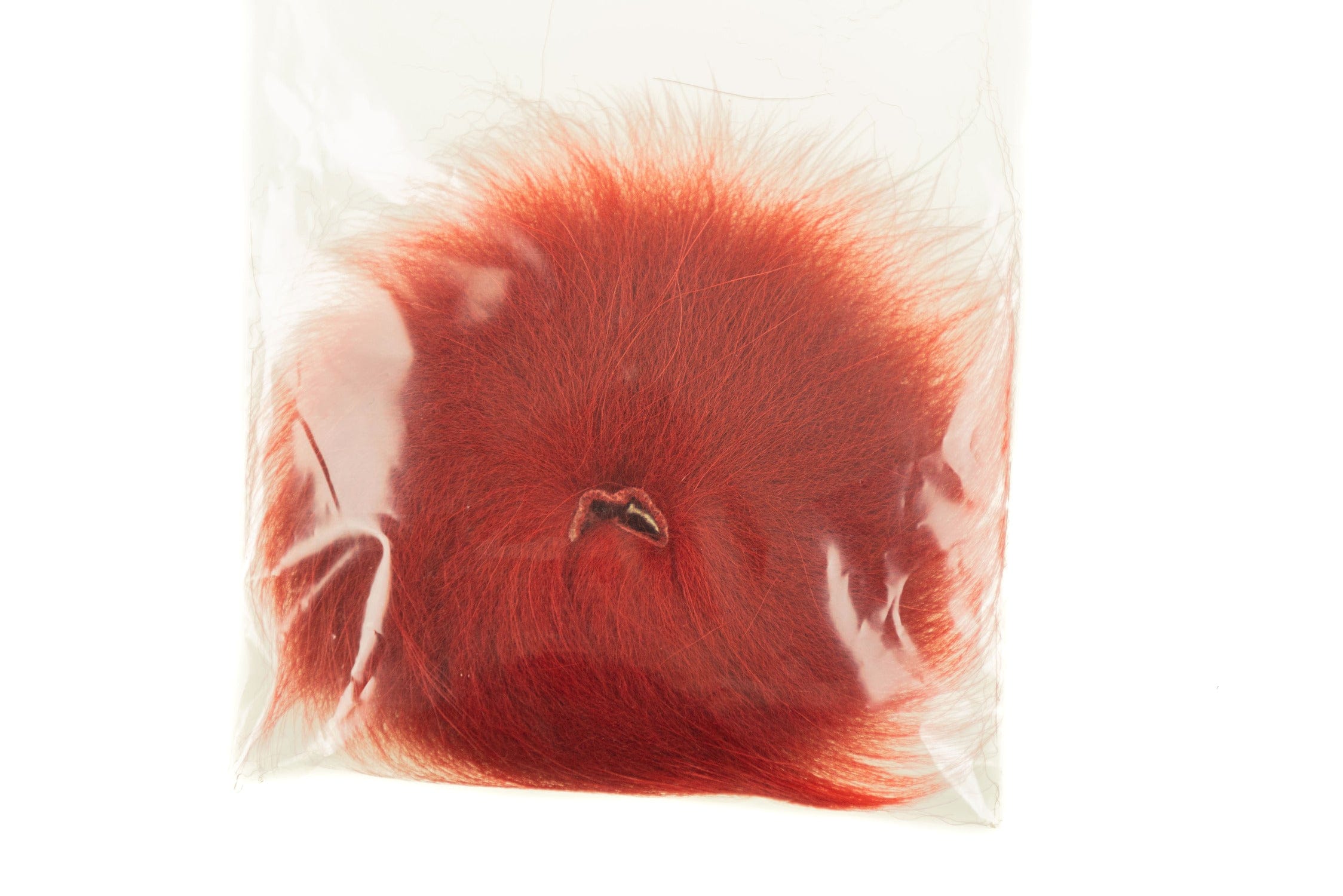 Rust-red Arctic Fisherman Mutation fox hair patch in clear plastic bag, fluffy fly tying fur