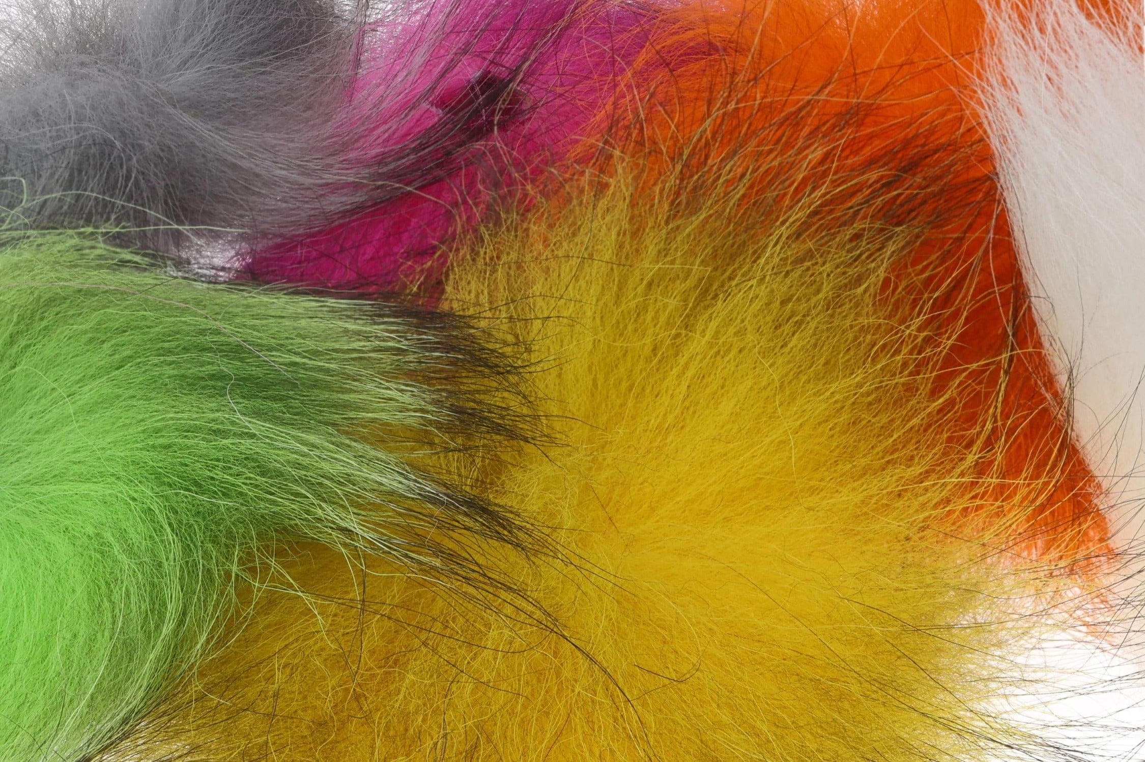Colorful Arctic Fisherman mutation fox hair tufts in neon green, yellow, orange, pink and gray for fly tying, soft wispy fur.