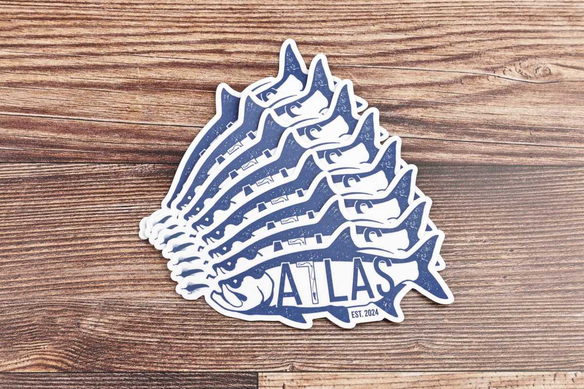 Stacked Atlas tarpon sticker, blue and white vinyl fish decal with distressed print on wood background