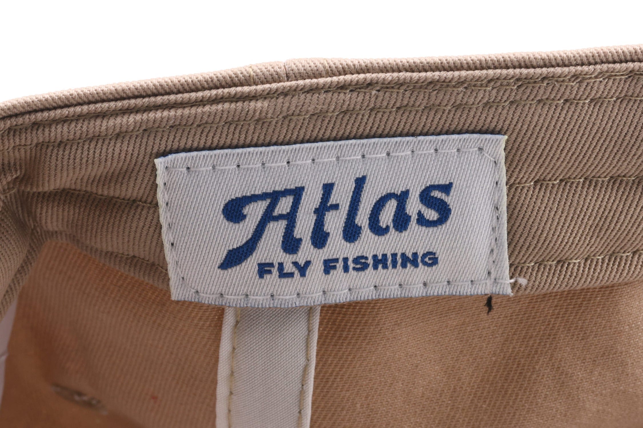 Beige cotton twill Atlas hat interior with white woven label showing blue Atlas script and stitched Fly Fishing logo.