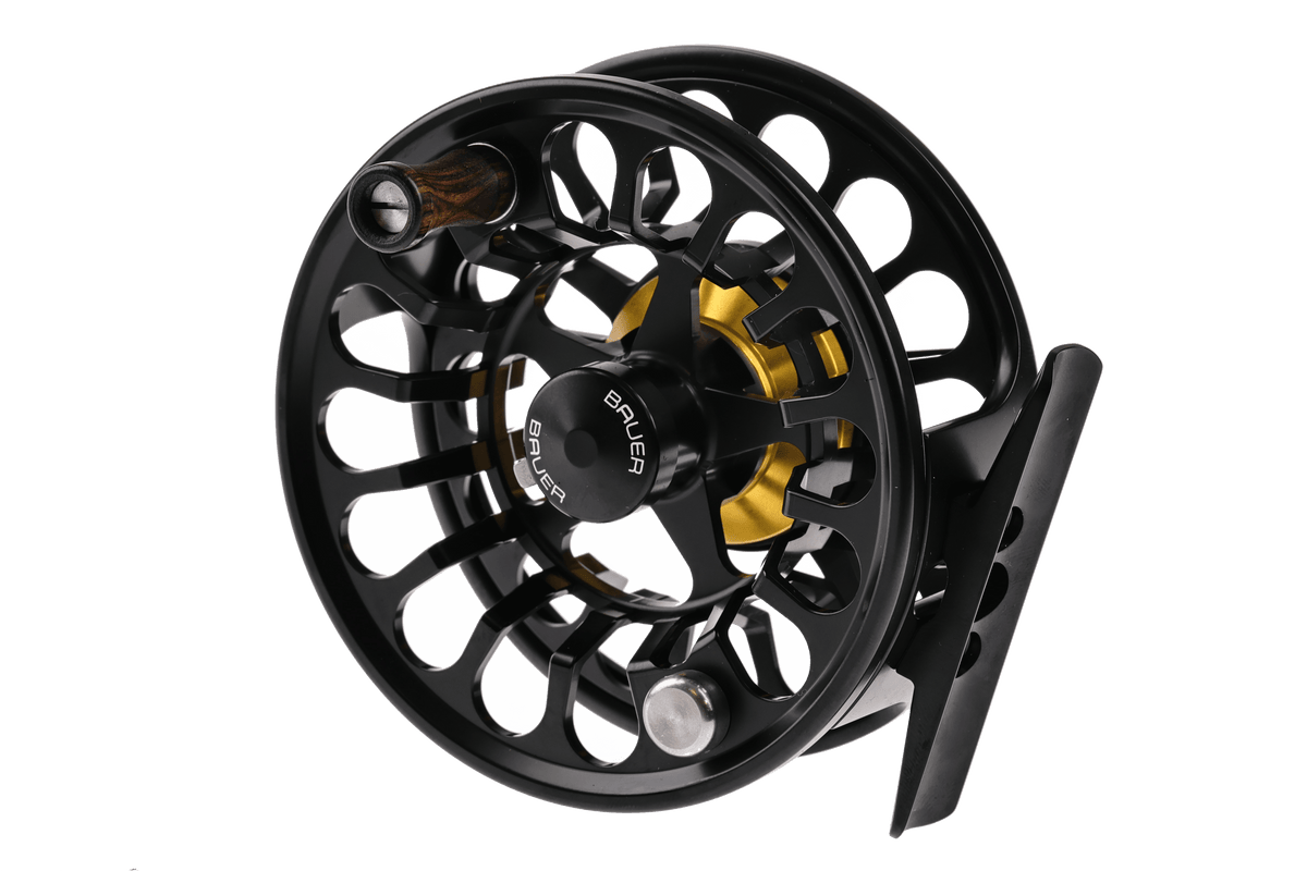 Black anodized Bauer RX fly reel with gold spool accents, ventilated machined aluminum frame and wood handle knob