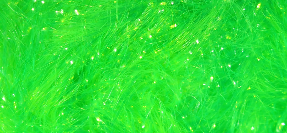 Chocklett's Gamechanger chenille in neon chartreuse with fluffy fibers and iridescent flash strands for fly tying