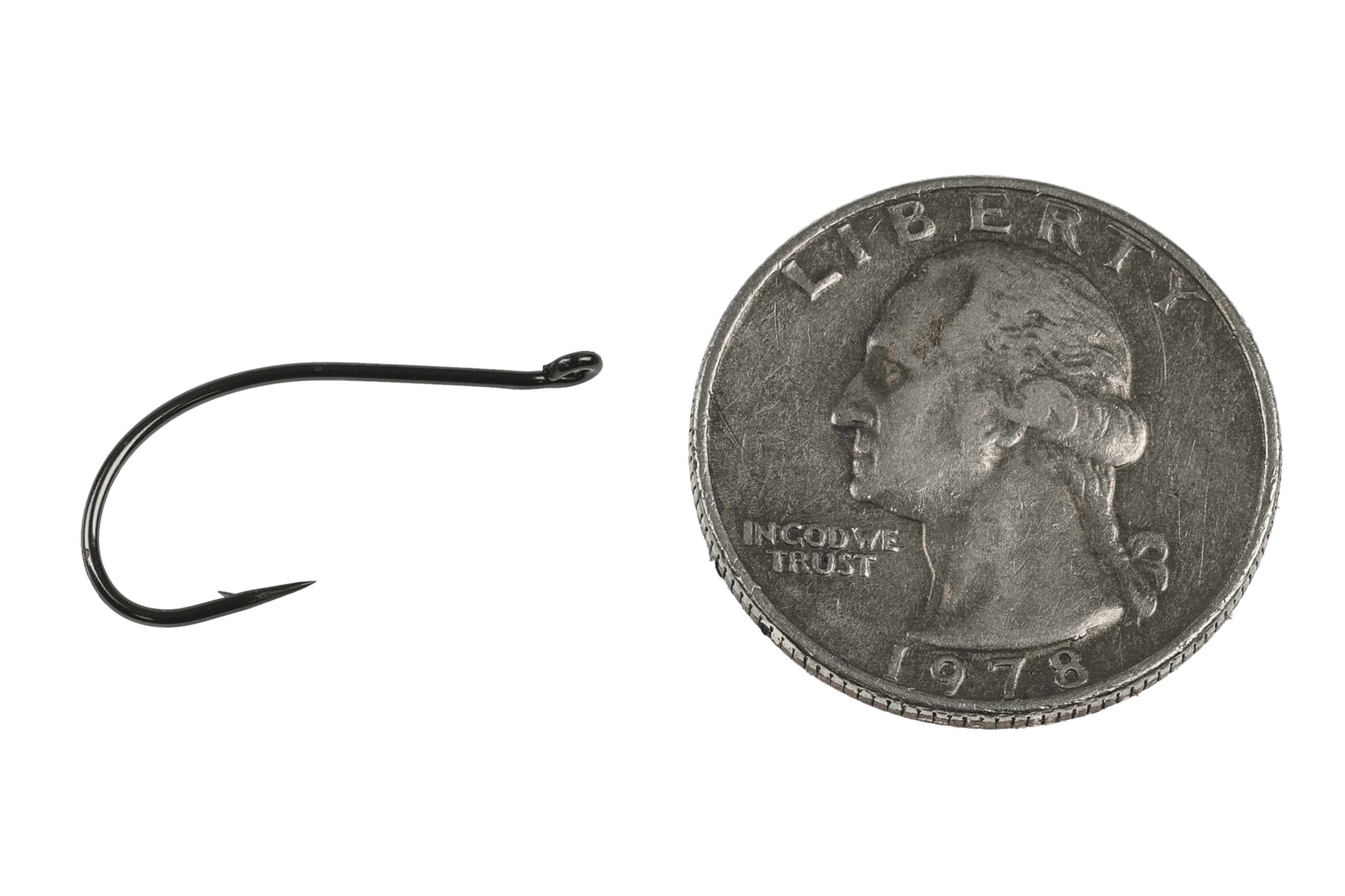 Black nickel curved emerger hook for fly tying with small barb and upswept eye beside US quarter for scale