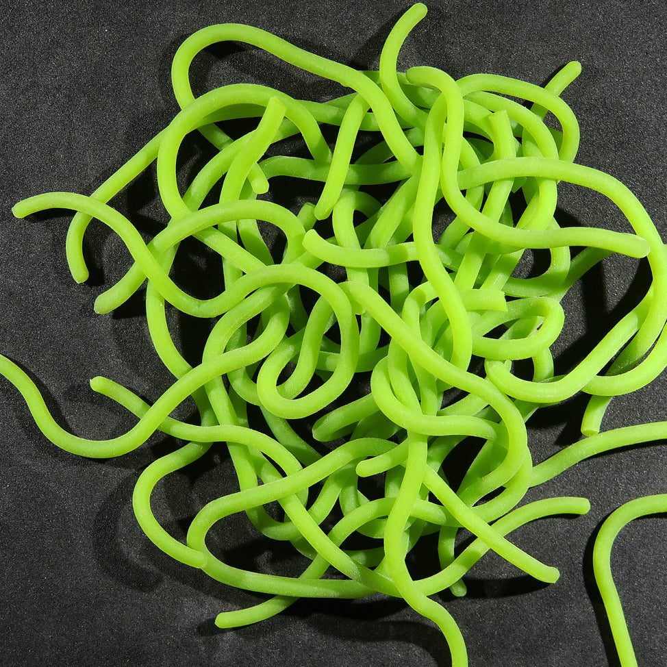 Hareline Squirmito neon chartreuse soft plastic curly tubular tentacles for fly tying on black background