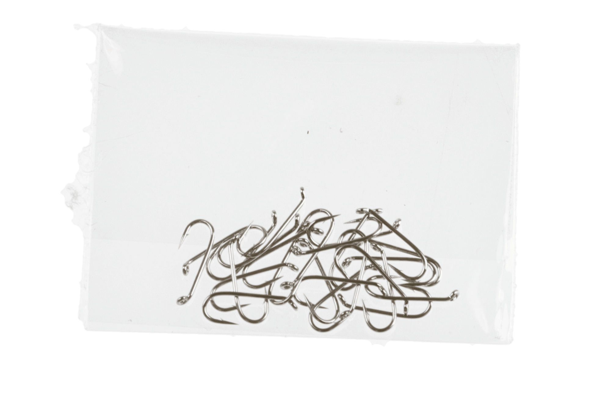 Small silver Daiichi dry fly hooks, curved shanks and sharp points in a loose pile on white card