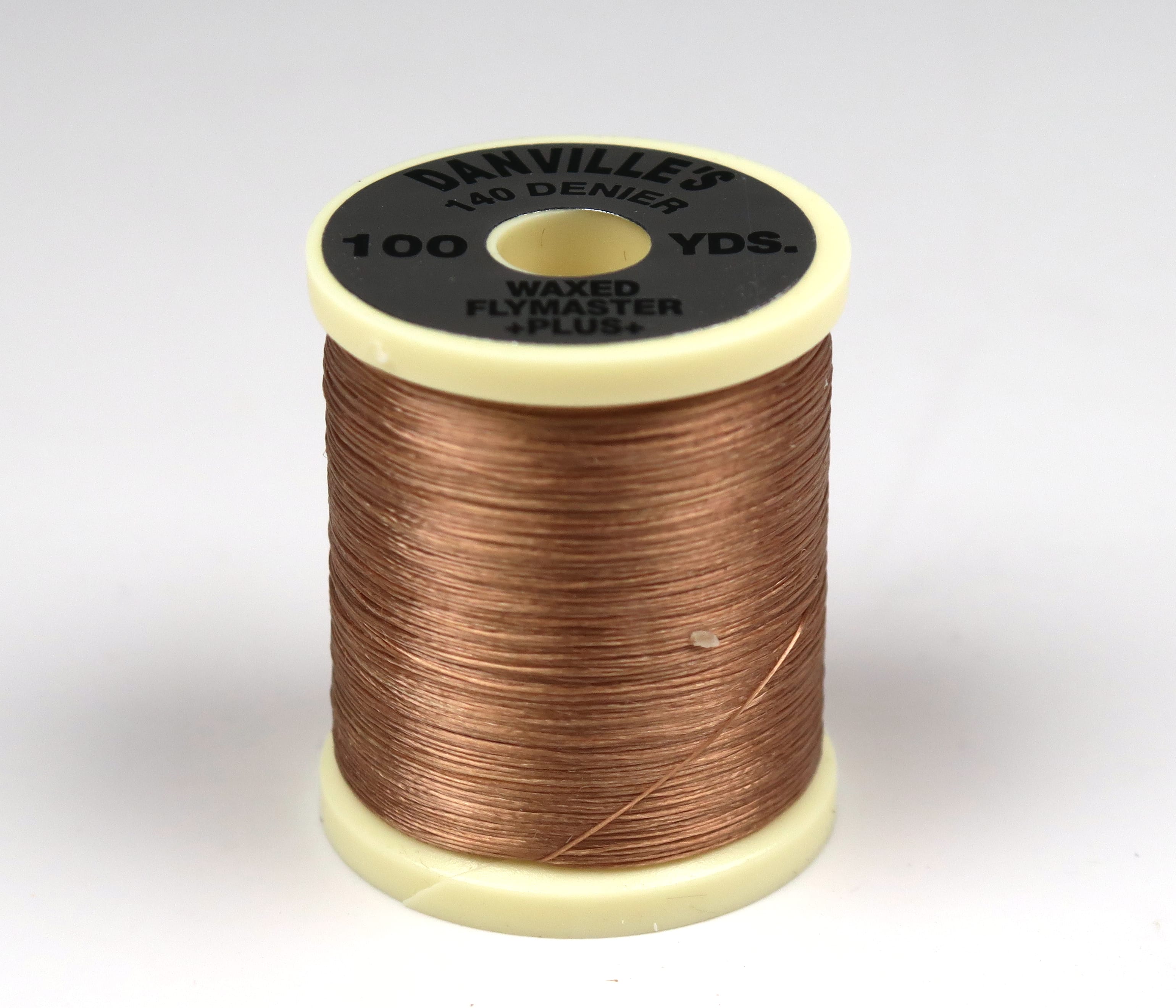 Copper waxed Danville spool of 140 denier fly tying thread with cream plastic ends and black label