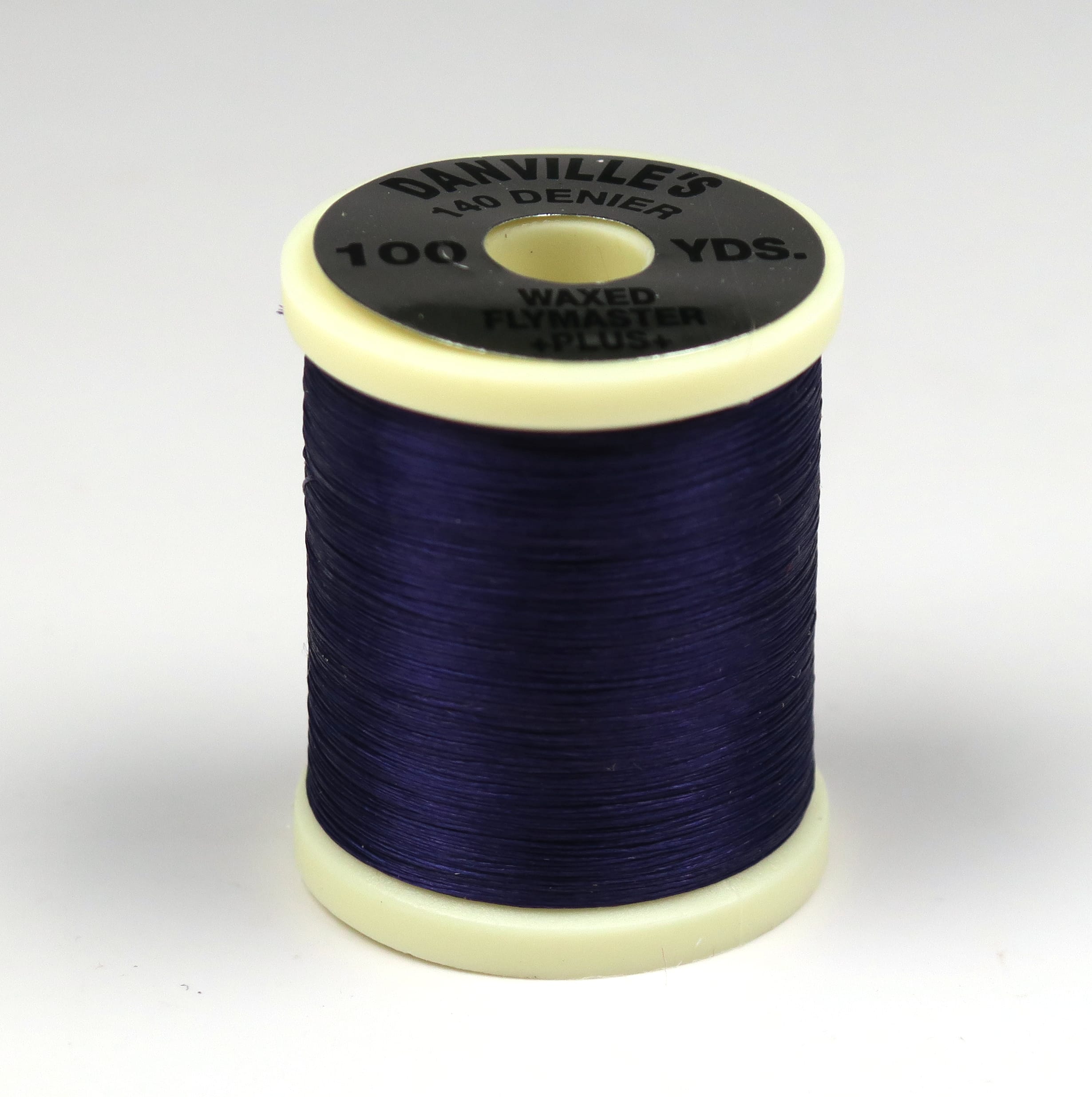Danville 140 denier waxed fly tying thread spool in deep navy purple with cream plastic top and black label