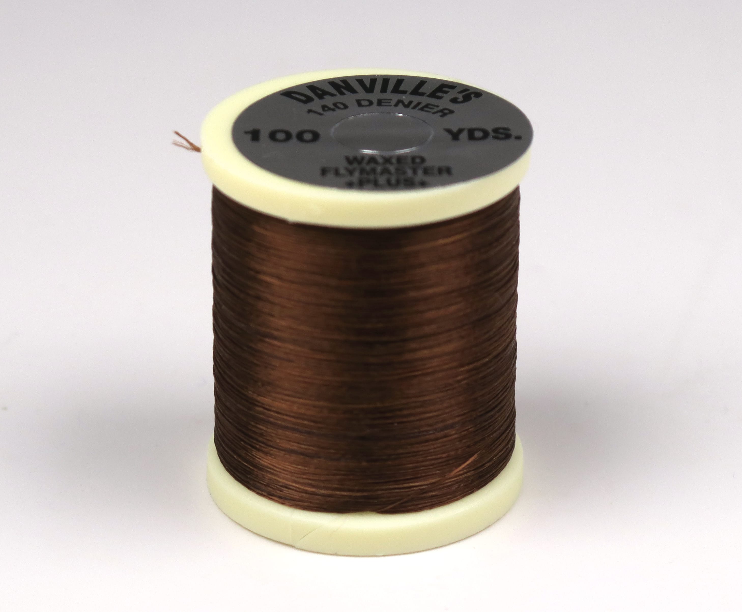 Danville waxed Flymaster 140 denier brown polyester thread spool with cream plastic top for fly tying