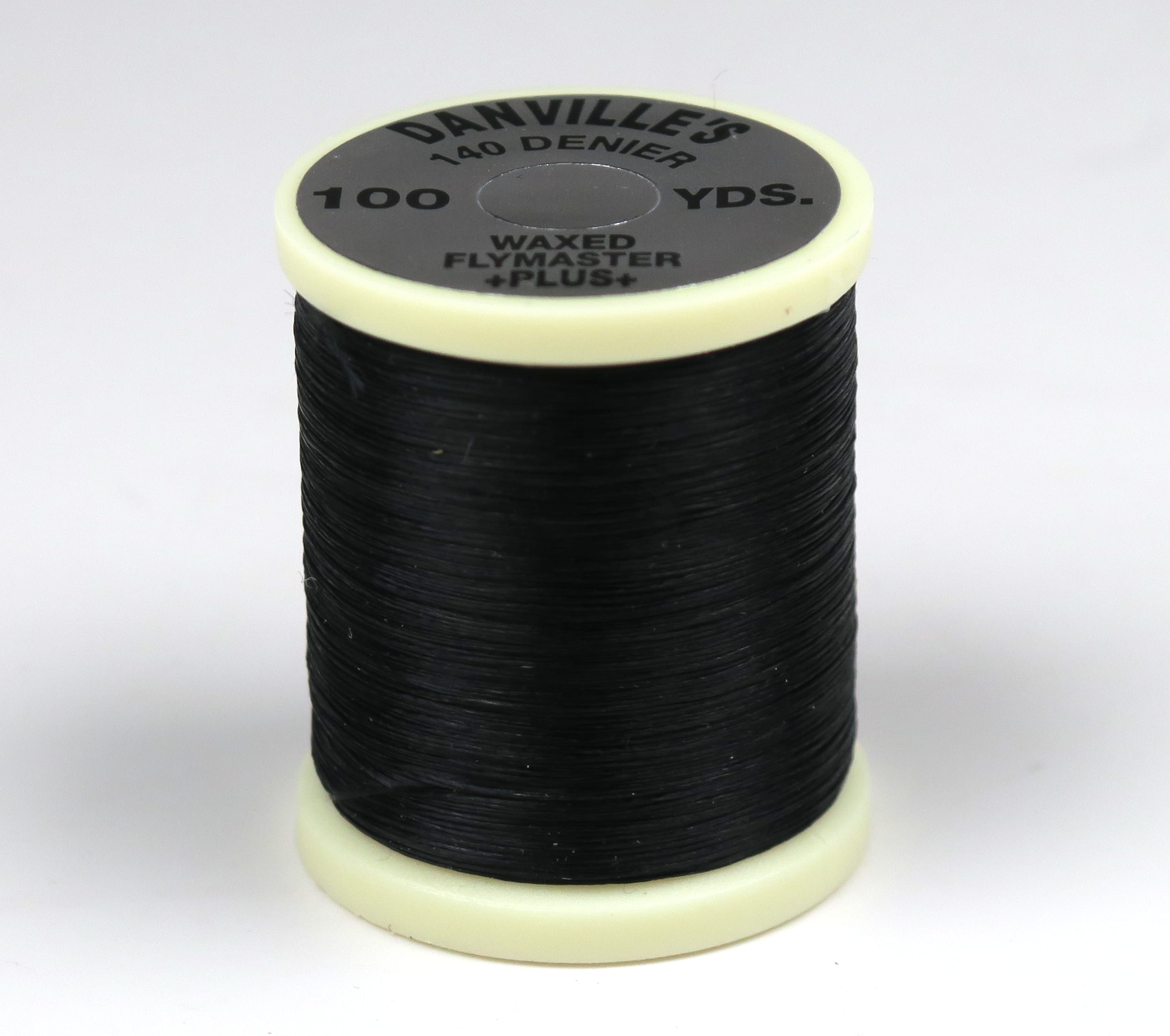 Danville 140 denier waxed fly-tying thread spool black on cream plastic bobbin with gray top label reading 100 yds
