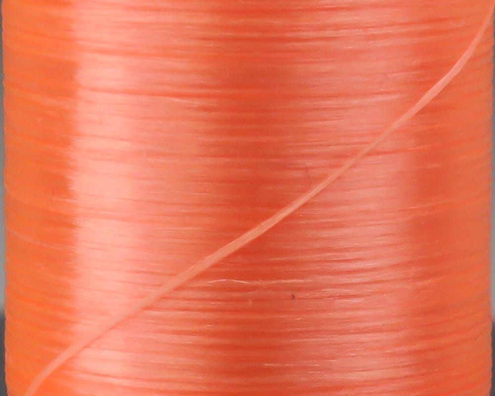 Coral orange flat waxed thread spool, glossy ribbon-like polyester layers for fly tying