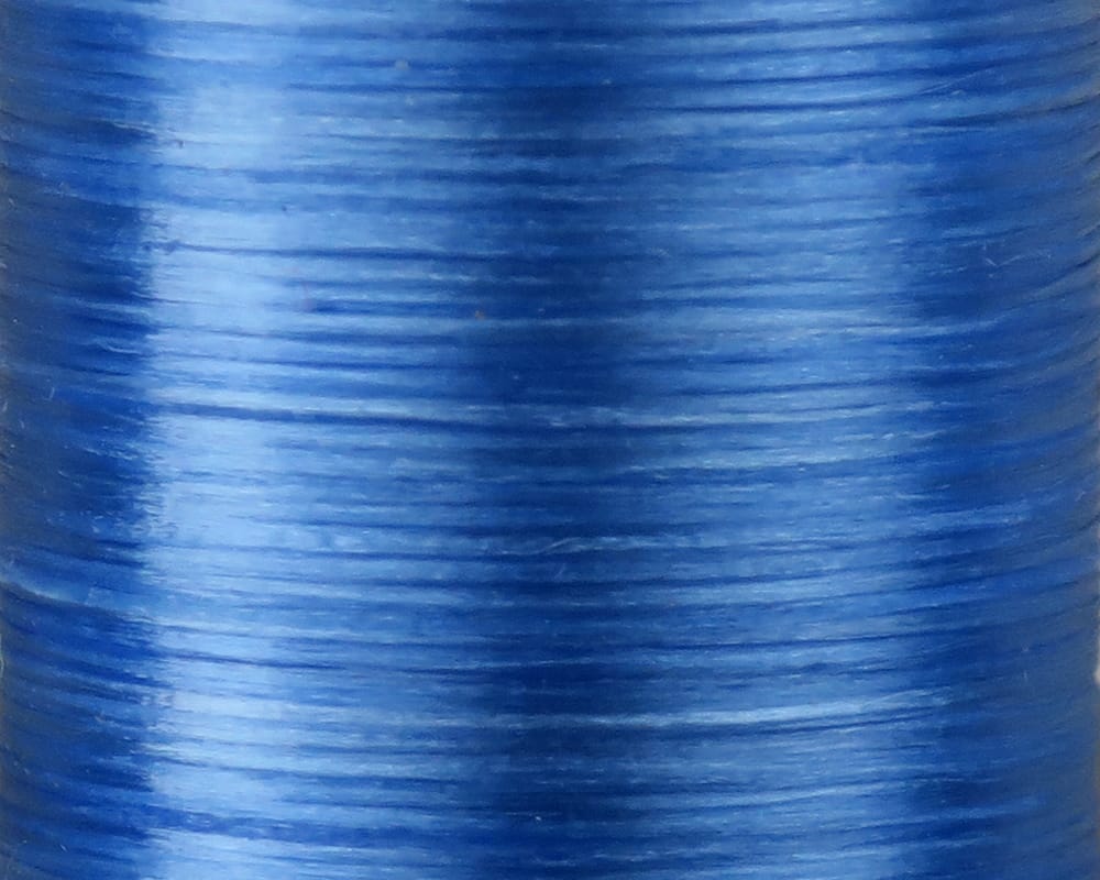 Cobalt blue Danville 210 denier flat waxed thread close-up with glossy, flat nylon filaments for fly tying
