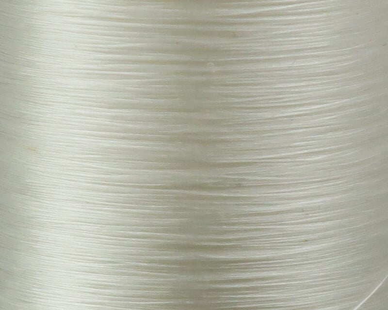 Danville Flymaster 6/0 translucent off-white nylon fly-tying thread spool close-up showing smooth glossy wound strands