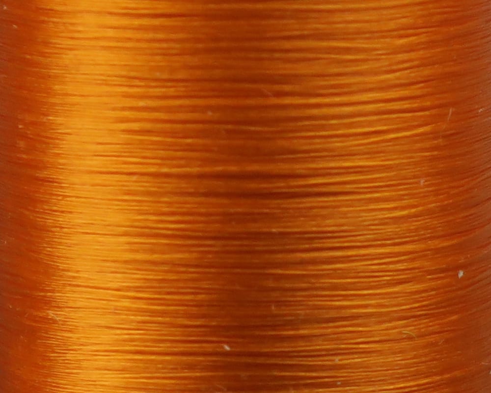 Danville Flymaster 6/0 glossy orange 70 denier fly tying thread spool close-up showing smooth fine synthetic strands