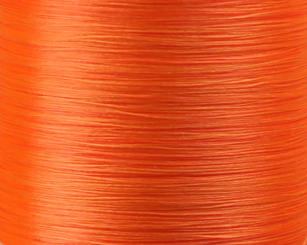 Bright orange Danville Flymaster 6/0 glossy nylon fly tying thread spool, close-up showing smooth fine strands.
