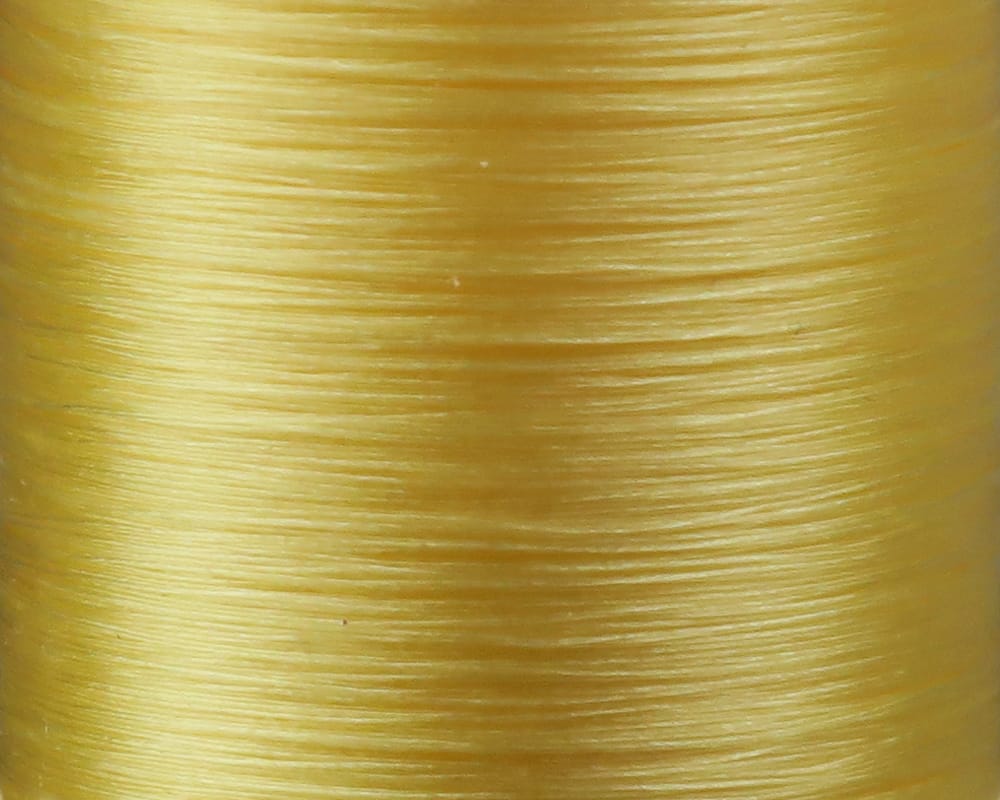 Danville Flymaster 6/0 glossy pale yellow nylon fly tying thread close-up showing smooth, shiny filament texture