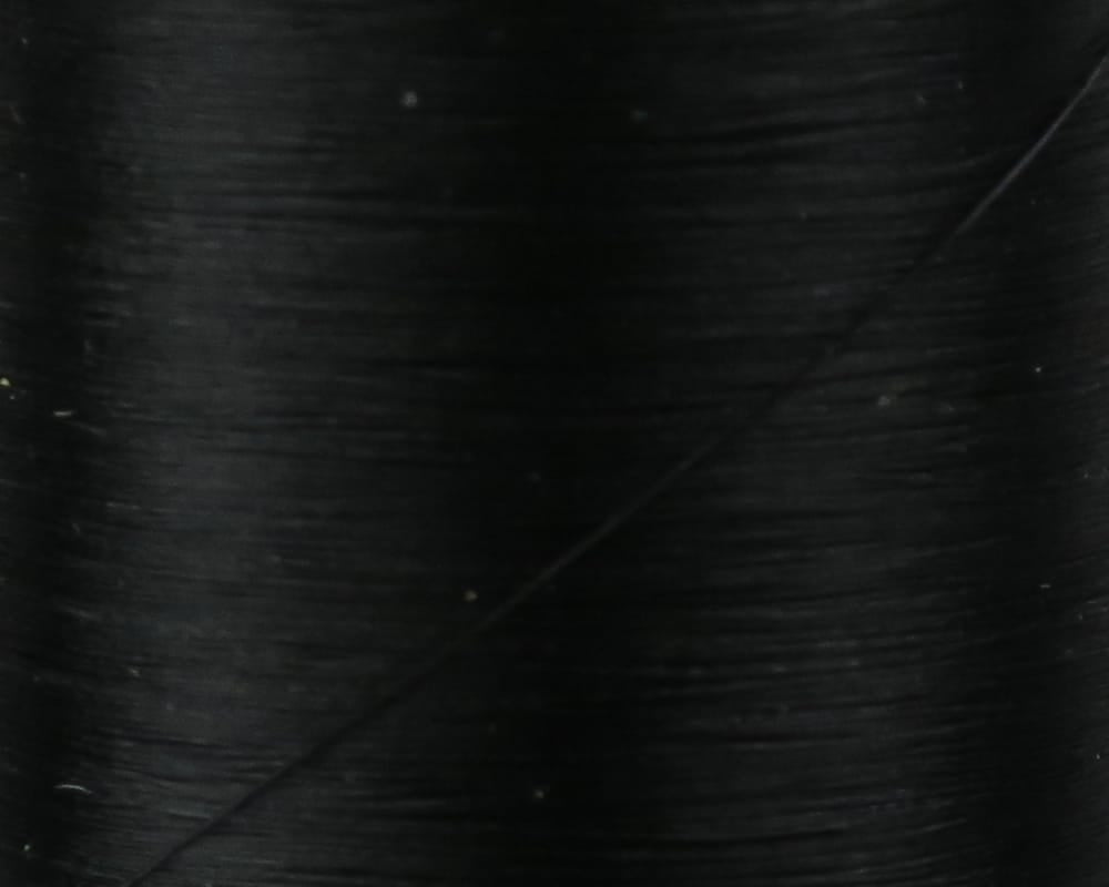 Danville Flymaster 6/0 70-denier black thread close-up showing smooth glossy nylon fly-tying thread on spool