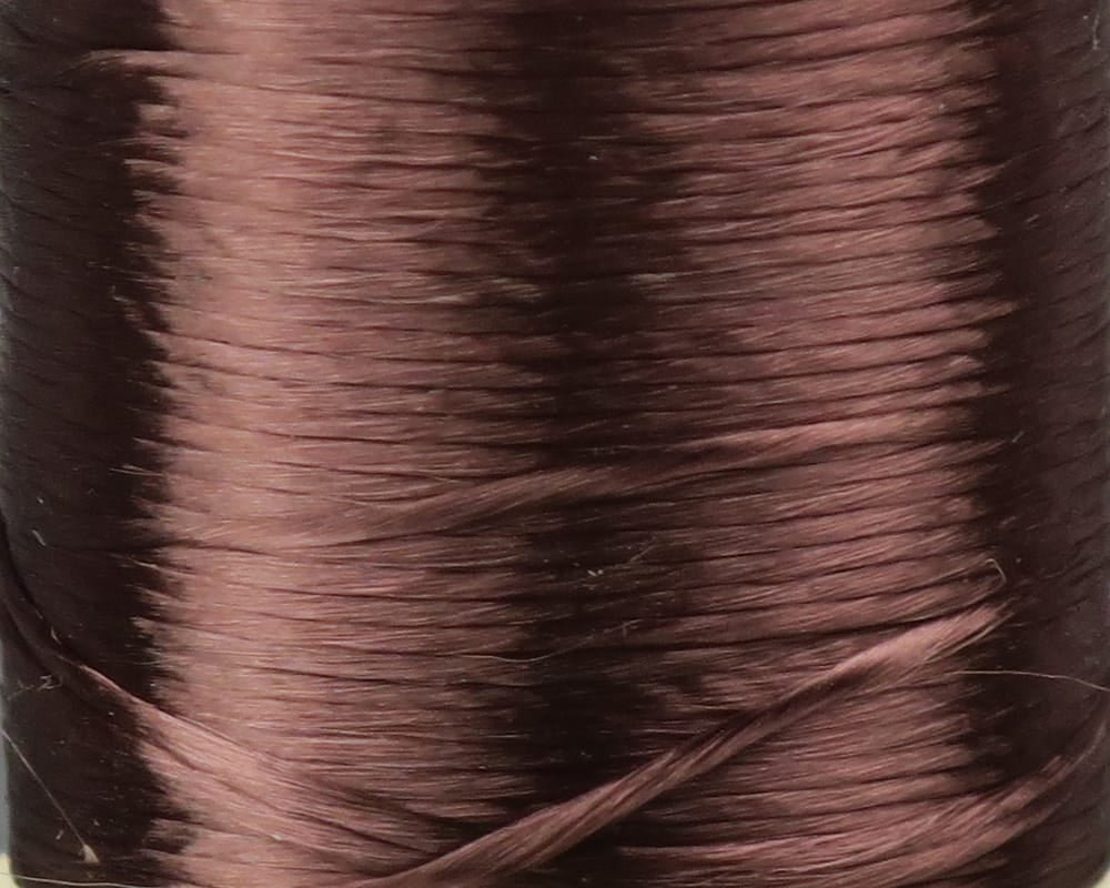 Close-up of glossy copper-brown acetate floss spool, smooth silky strands tightly wound for fly tying