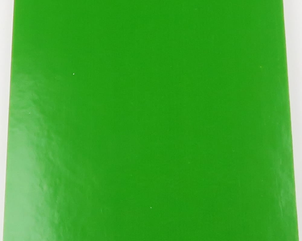 Bright green glossy Fino Skin sheet with smooth synthetic texture, rectangular fly tying material on white background