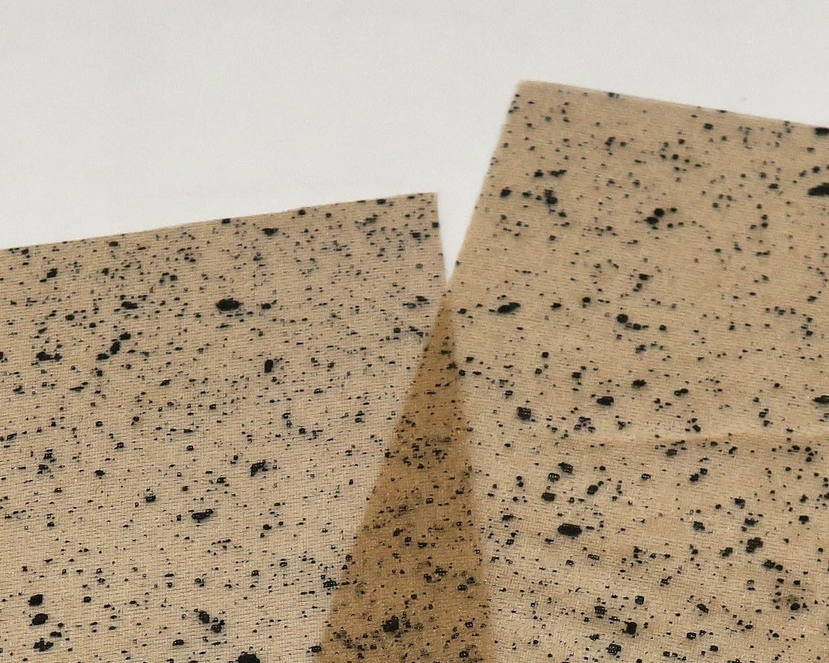Tan mottled web wing material with black speckles, translucent synthetic sheets for fly tying