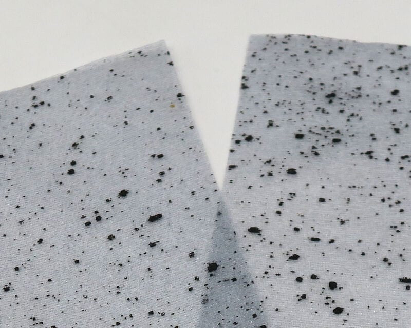 Pale gray mottled web wing material with black speckles, fine synthetic fabric for fly tying
