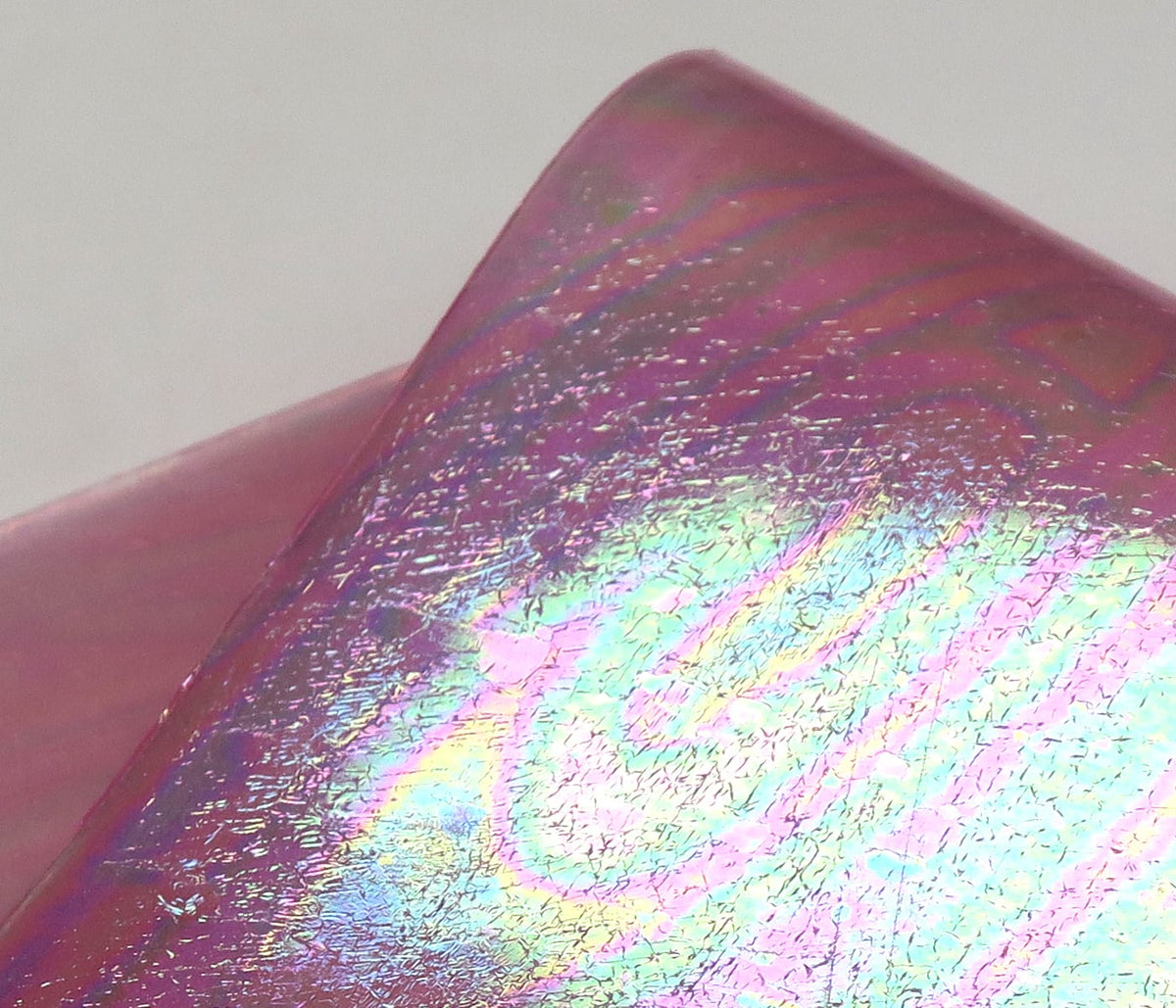 Iridescent pink UV Chewee Skin sheet with holographic rainbow sheen and cracked foil texture for fly tying