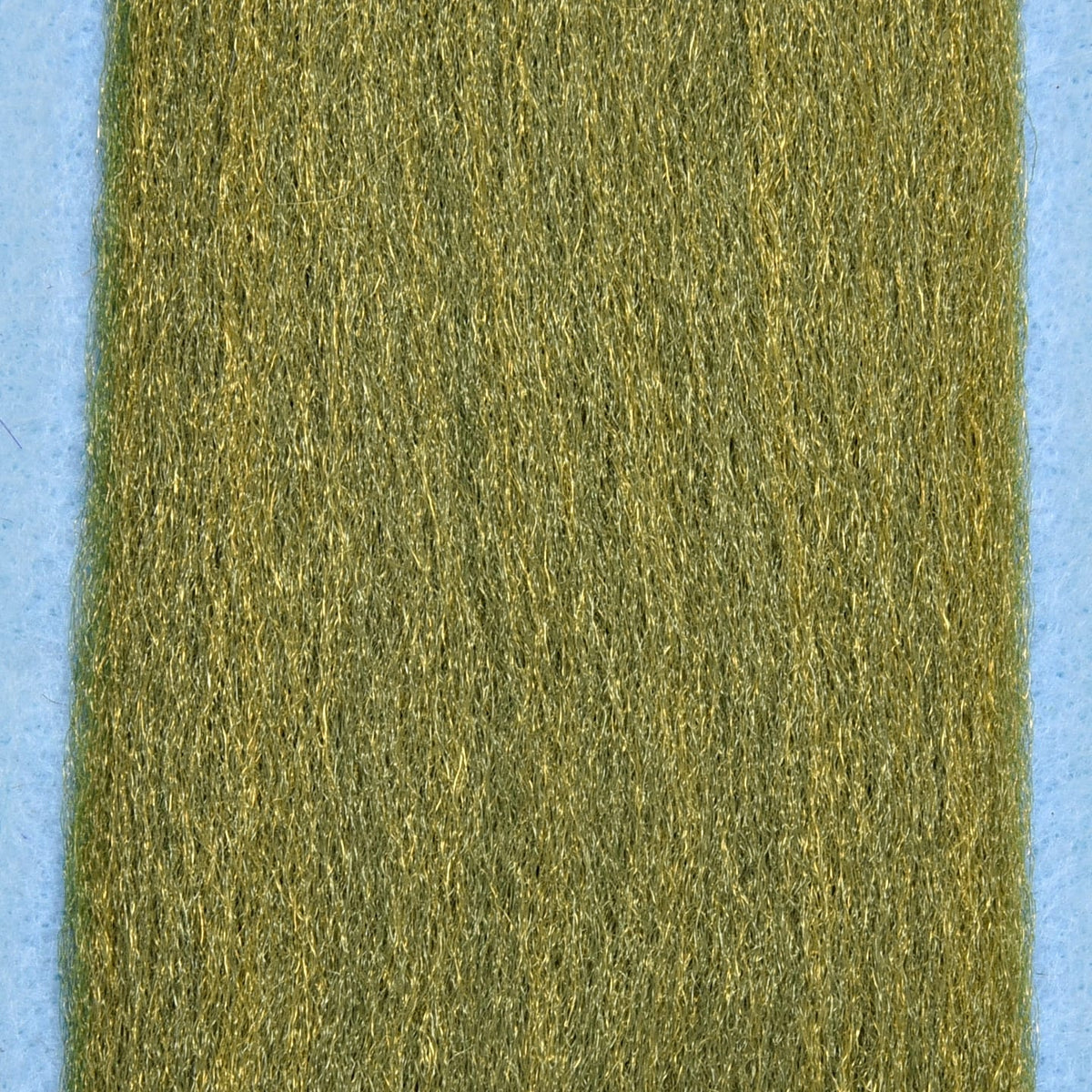 Olive green synthetic 3D fibers with gold shimmer for fly tying, dense textured strands on light blue backing
