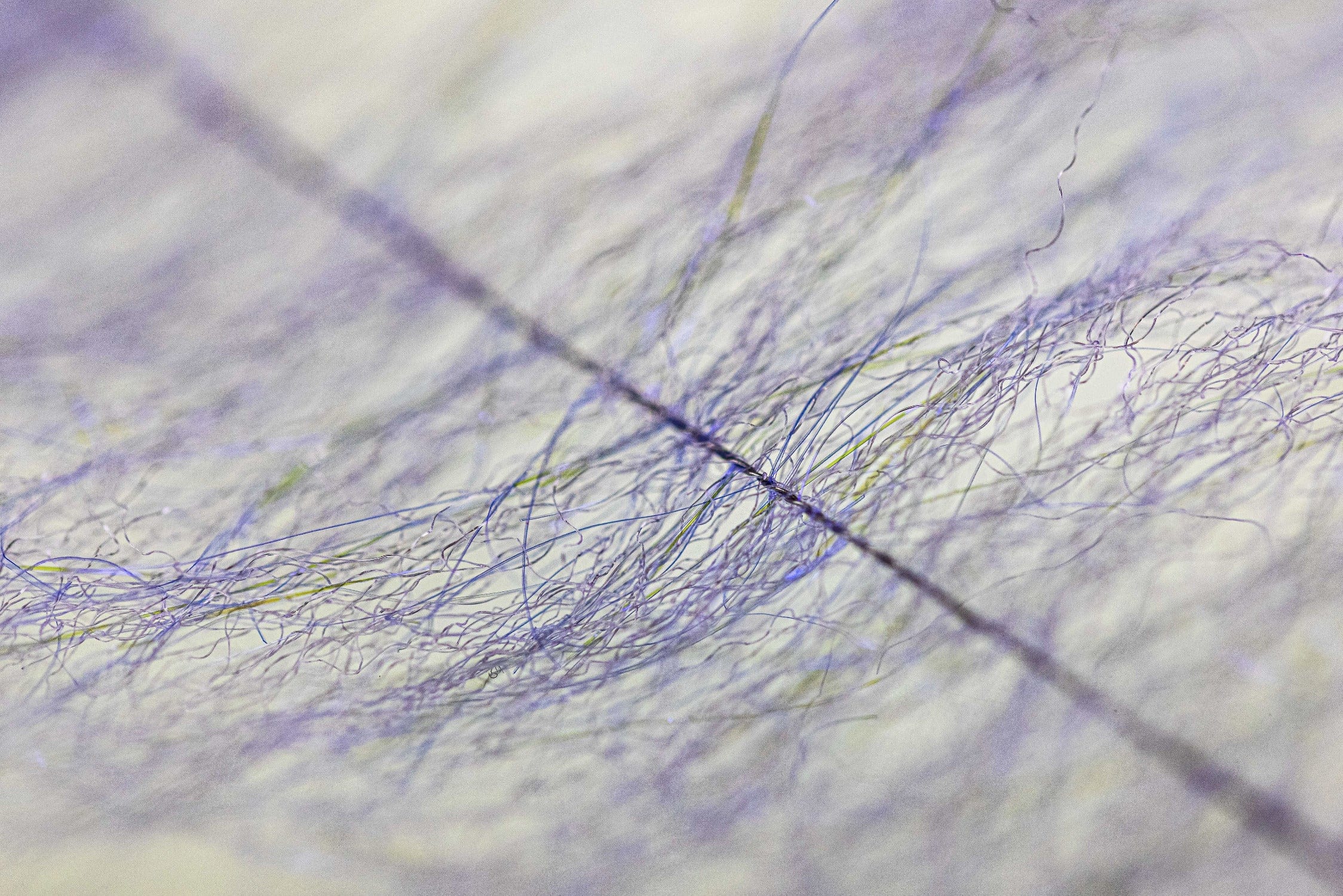 Lavender Anadromus brush close-up showing airy synthetic fibers and iridescent strands for fly tying