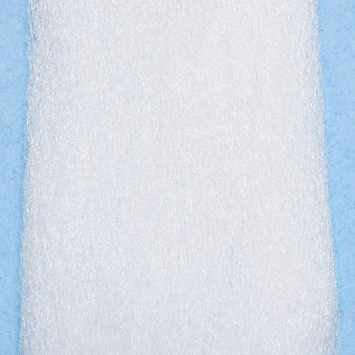 White Enrico Puglisi EP Fibers, sparkly synthetic fine strands on pale blue backing for fly tying