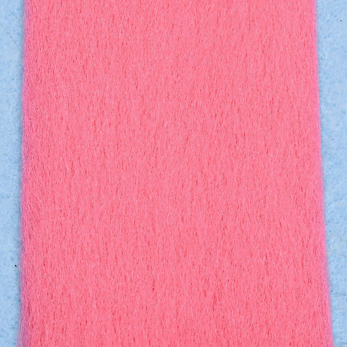 Bright pink Enrico Puglisi EP Fibers strip, soft synthetic fly-tying fibers with fine fuzzy texture on light blue backing