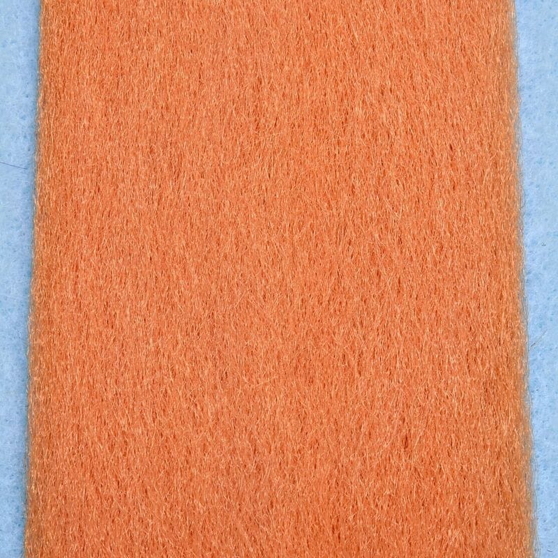 Orange synthetic fly-tying EP fibers strip with fine fuzzy texture on light blue backing