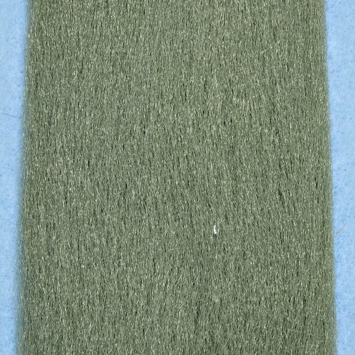 Olive green Enrico Puglisi EP synthetic fibers for fly tying, fine shimmering hair-like strands on blue backing.