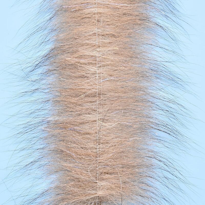 Tan fox fur brush strip with long wispy guard hairs, subtle flash fibers and stitched center spine for fly tying