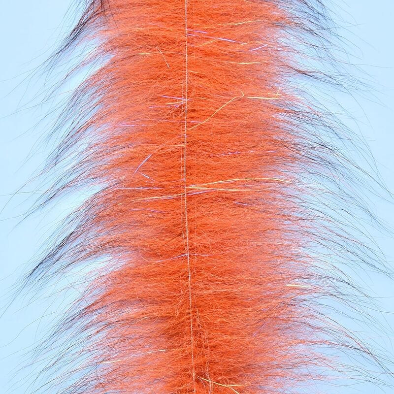 Orange Foxy Brush strip with long black-tipped guard hairs and iridescent flash fibers for fly tying