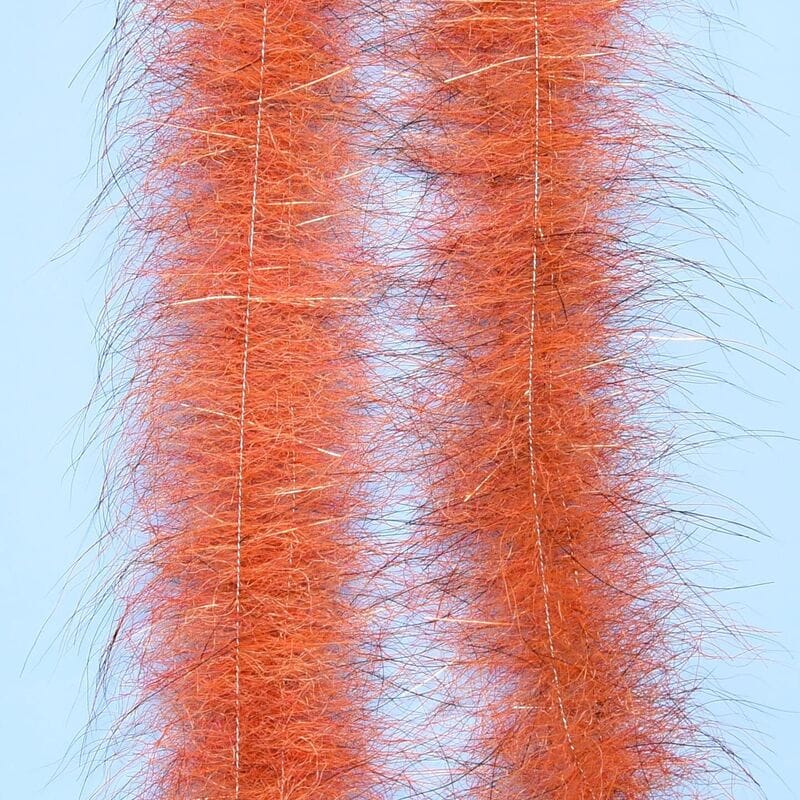 Orange Enrico Puglisi Foxy Brush with long fluffy synthetic fibers and gold tinsel strands for fly tying