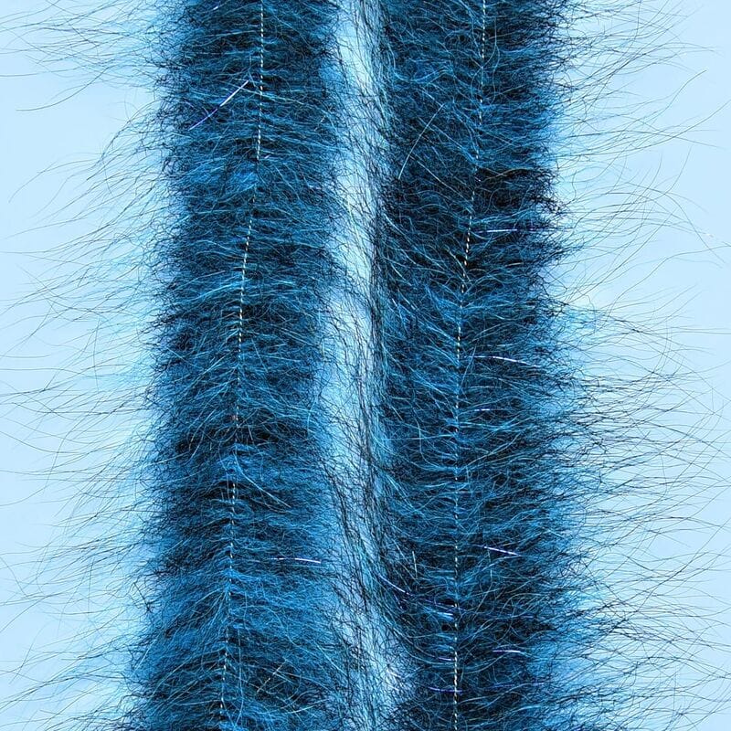 Two blue Enrico Puglisi Foxy Brush strips with long furry fox fibers and silver tinsel core for fly tying